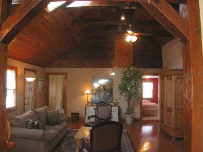 Living room has skylight, beamed ceilings, hardwood floors