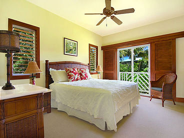 The large master bedroom has a firm California king bed, TV, and adjoining bathroom.