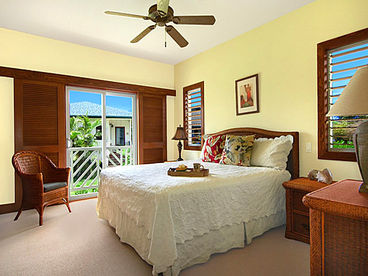 The large master bedroom has a firm California king bed, TV, and adjoining bathroom.