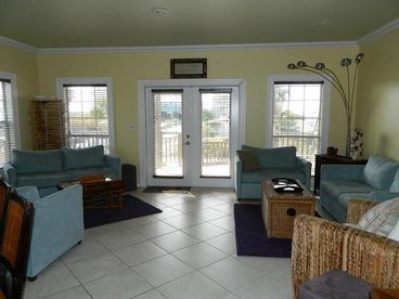 Open plan living room looking out to beach view porch