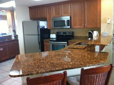 The spacious granite counters offer a great place for breakfast or afternoon cocktails and snacks.