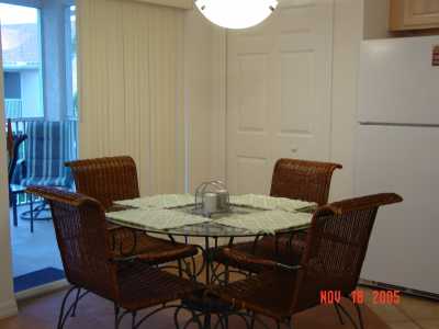 This is the dining area off the kitchen with sliders to the balcony which overlooks the pool and the gardens.