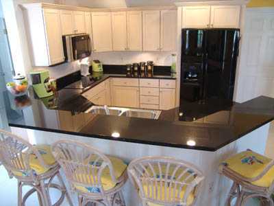 Ultra modern black granite kitchen with breakfast bar for 4