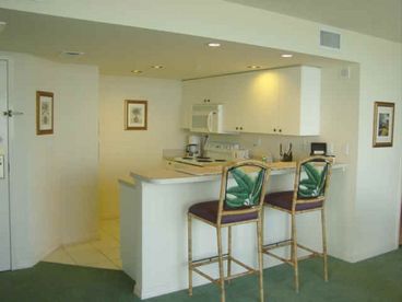 Full kitchen with counter stools