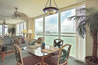 Dining and living room overlooks a wall made of glass facing Estero Bay!