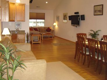 The living room has a Plasma TV, three couches, and bamboo floors