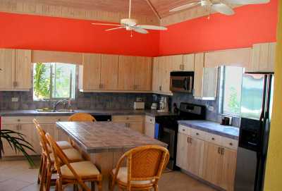 OUR WELL EQUIPPED AND SPACIOUS KITCHEN WITH LARGE CENTER ISLAND AND 6 BAR STOOLS WITH BACKS.