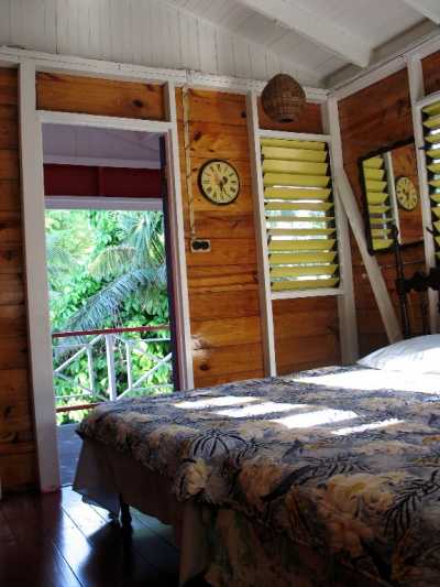 One of the upstairs bedrooms- no need for air conditioning- it is always cool and breezy from the ceiling fans and the shade of the tree's