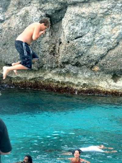 Jumping off a boat at Josephs cave on the cliffs 