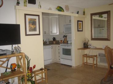 New kitchen with granite and travertine floors, ceramic cook top. Also computer station with highspeed internet