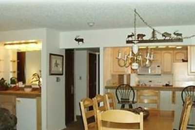 Fully equipped kitchen, breakfast bar, dining area.