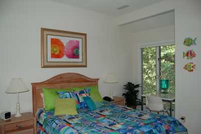 Decorated in fun, bright colors, the master bedroom offers a caribbean style escape.