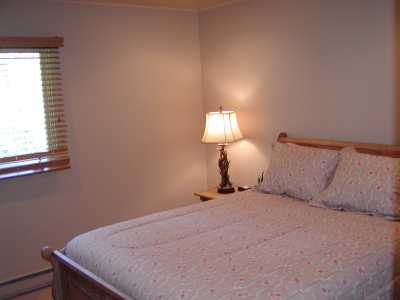 2nd bedroom features a queen size bed and flat screen Tv.