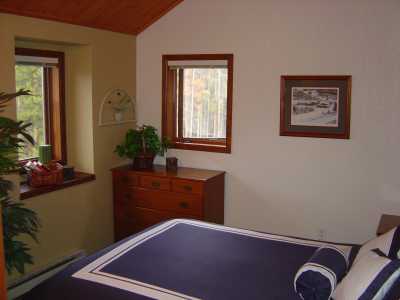 Bedroom with Queen Bed and a vaulted pinewood ceiling