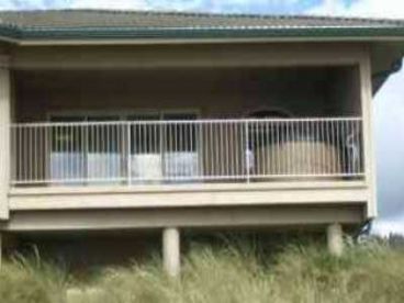 The covered deck. Has hot tub, BBQ and chairs for relaxing