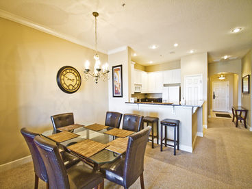 A shot of the dining area and kitchen.