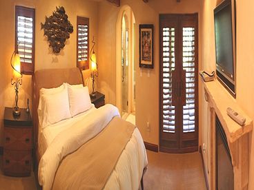 Exquisite Master Suite with King Bed, large walk-in Closet, fireplace, luxury bath, large flat panel TV and french doors open to rear patio garden.
