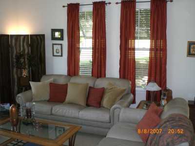 Living room with golf course views in the background.