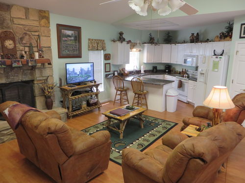 The spacious great room with comfortable seating, stone gas fireplace, 40\
