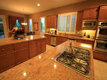 Sparkling gourmet kitchen has two giant islands, slab granite, 5 burner gas cooktop, double ovens, two dishwashers...all set for your large group.
