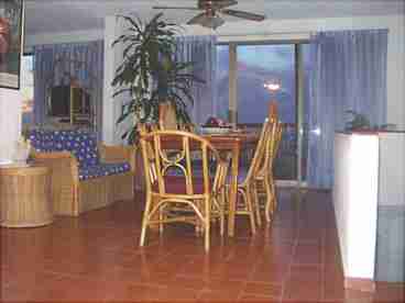 Dining Room seats 8, also has love seat, kitchen
is behind it they view ocean from sliding doors.