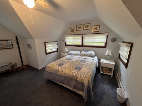 Newly painted master bedroom features a queen size bed surrounded by windows on three sides so you can capture the evening lake breezes. Sitting area, cot, a dresser, and closet are part of the master bedroom as well.