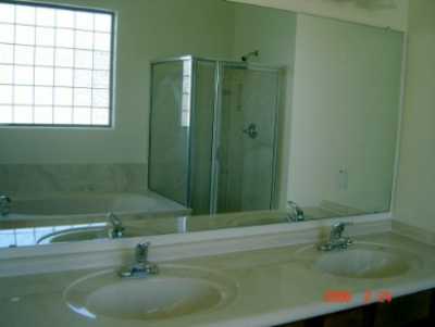 Master bathroom with double vanity and separate shower and marble bathtub.