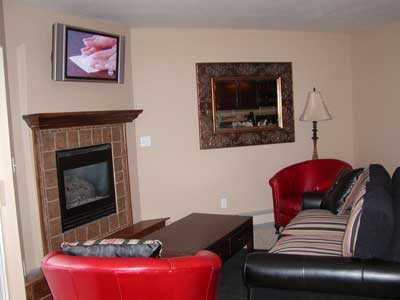 Living room with LCD TV, gas fireplace, queen sleeper sofa and views of Beaver Creek