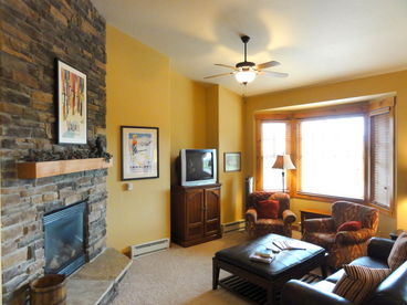 Living Area - large rock  gas fireplace, custome finishes, alcove windows, large deck with great views!