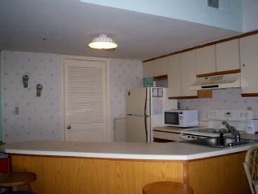 Full size kitchen with stove, fridge, microwave, dishwasher, coffee pot and all kitchen utensils