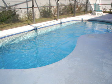 Private fully screened pool with extended deck area with sun loungers. Covered lanai with patio furniture for al fresco dining