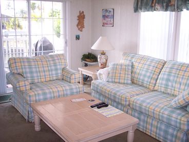 Living room with light bright  tropical furniture, great for entertaining!