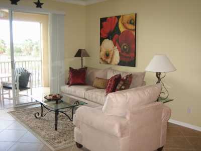 Living Room has new tiles, furniture, TV and accessories.  The living room offers access to the screened in lanai.