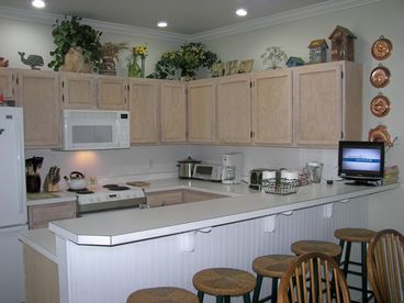 Kitchen with breakfast bar and flat screen television!