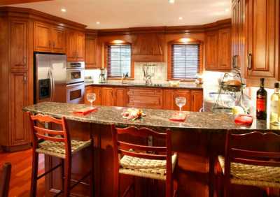 Gourmet kitchen with stainless steel appliances, granite countertop, eating bar.