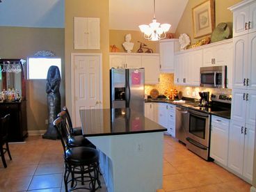 Kitchen in main house with granite counters, upgraded stainless steel appliances, and tile back splash!