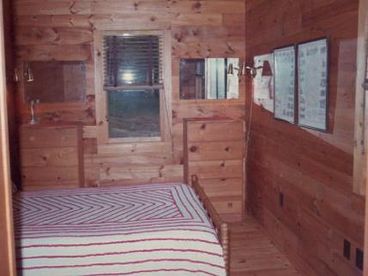 Has queen-sized bed.   Window overlooks the lake.  Bunk Room appears similar, and can be two twins, or a king.
Central heating - but no need in the summer.  No air conditioning -- No wait!  The natural a/c is better.  Rarely is it humid.