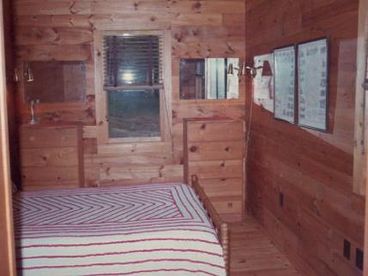 Has queen-sized bed.   Window overlooks the lake.  Bunk Room appears similar, and can be two twins, or a king.
Central heating - but no need in the summer.  No air conditioning -- No wait!  The natural a/c is better.  Rarely is it humid.