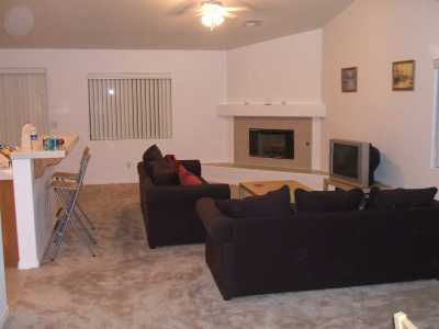 Lounge Are, large sofas, fireplace,TV/DVD/VCR, new carpet, breakfast bar to kitchen area.