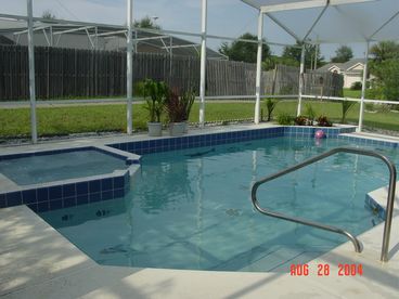 The private screened-in pool and adjoining spa.