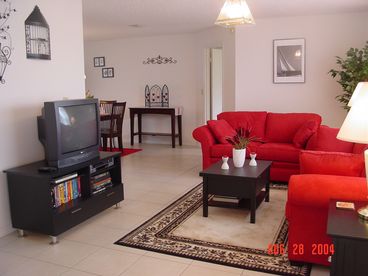 The spacious living room, complete with TV/VCR/DVD and queen-sized sleeper sofa.