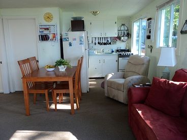 Living and dining area with sliders out to a 28 foot private deck overlooking the water.