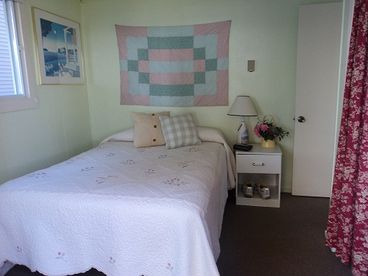 Main bedroom with two sliders leading out to deck and views of the water from inside as well as outside.