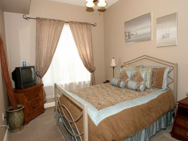 Guest bedroom with cable TV, a ceiling fan to keep you cool, queensize pillowtop bed