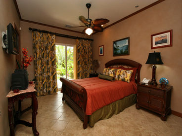 Master Bedroom with Safe, sliding doors to outside, private bath, large closets and built in shelves, closets.