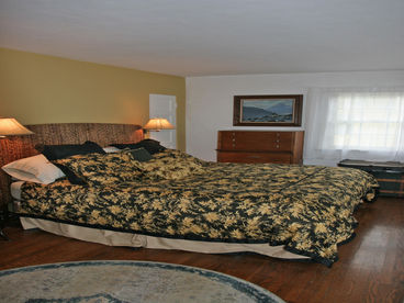 The master bedroom has a king size bed and a single sleeper sofa