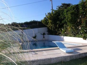 Pool with grass area, table, chairs and bbq