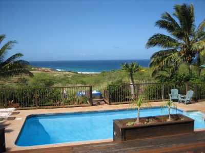 view of pool, jacuzzi and Papohaku Beach with the Pacific Ocean (in the distance is diamond head)