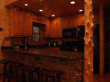 Gourmet fully furnished kitchen w/ granite counter tops and custom column