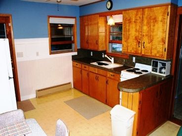 Kitchen/Eating Area.  Includes stove/oven, refrigerator,  microwave, and dishwasher.